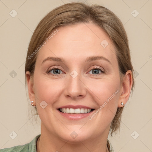 Joyful white adult female with medium  brown hair and blue eyes