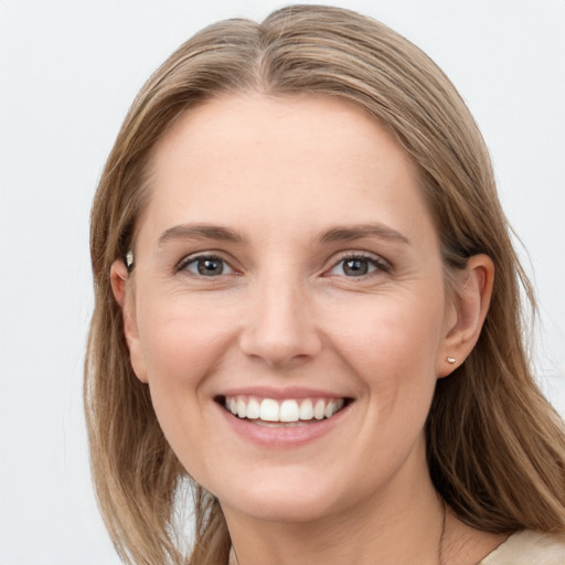 Joyful white young-adult female with long  brown hair and blue eyes