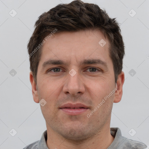 Joyful white adult male with short  brown hair and grey eyes