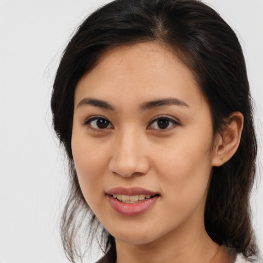 Joyful latino young-adult female with medium  brown hair and brown eyes