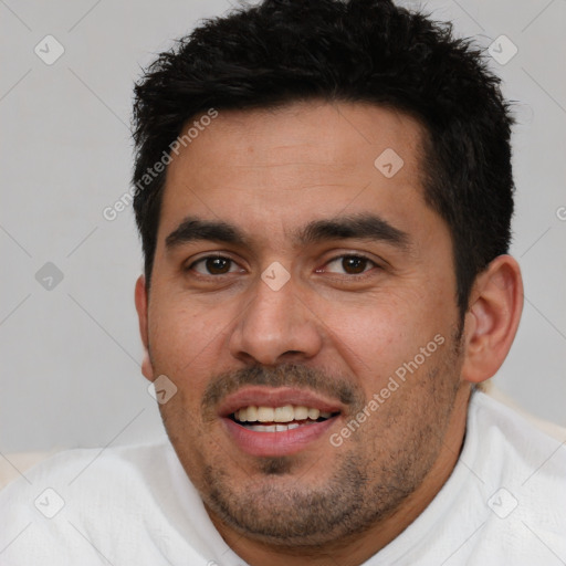 Joyful white young-adult male with short  black hair and brown eyes