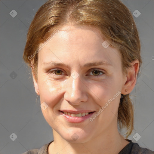 Joyful white young-adult female with medium  brown hair and grey eyes