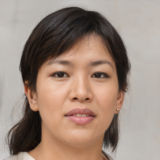 Joyful asian young-adult female with medium  brown hair and brown eyes