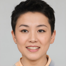 Joyful asian young-adult female with short  brown hair and brown eyes