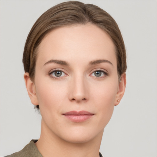 Joyful white young-adult female with short  brown hair and grey eyes