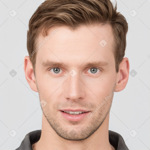 Joyful white young-adult male with short  brown hair and grey eyes