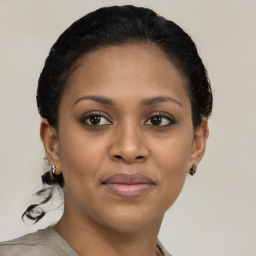 Joyful black young-adult female with short  brown hair and brown eyes