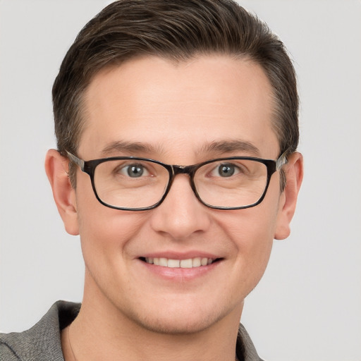 Joyful white young-adult male with short  brown hair and grey eyes