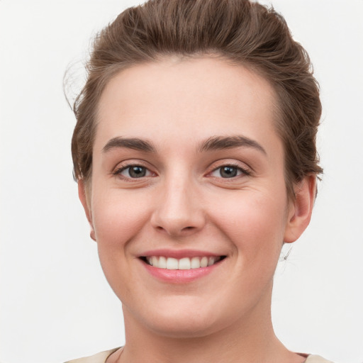 Joyful white young-adult female with short  brown hair and grey eyes