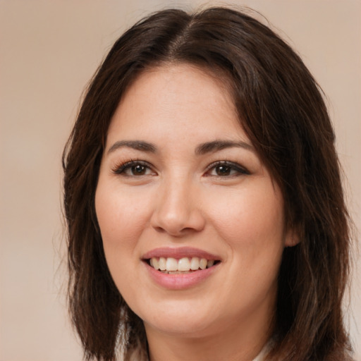 Joyful white young-adult female with long  brown hair and brown eyes