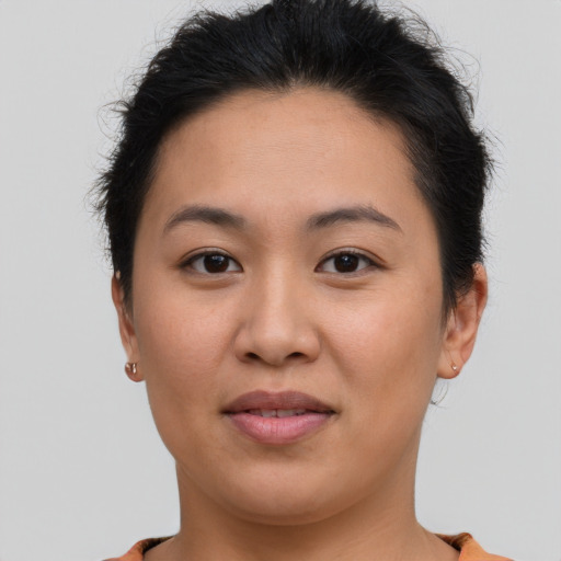 Joyful asian young-adult female with short  brown hair and brown eyes