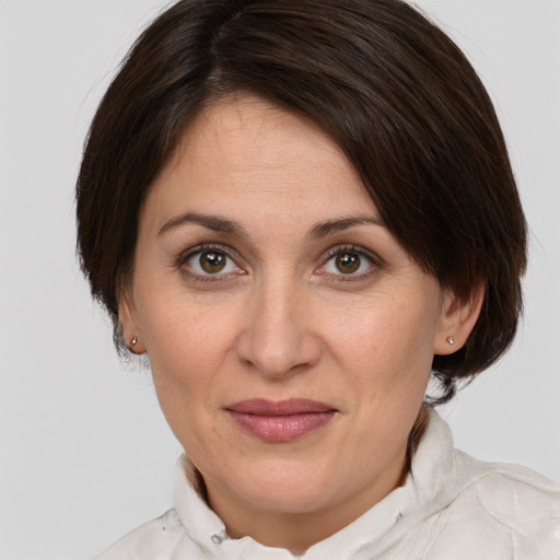 Joyful white adult female with medium  brown hair and grey eyes