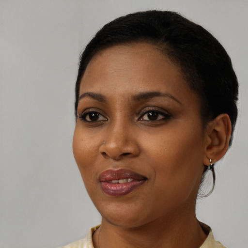 Joyful black young-adult female with short  black hair and brown eyes