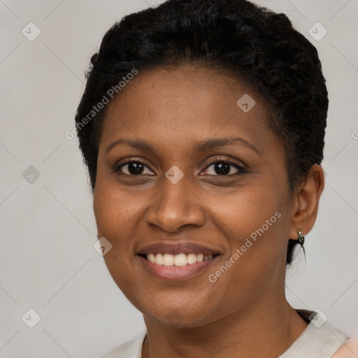 Joyful black young-adult female with short  brown hair and brown eyes