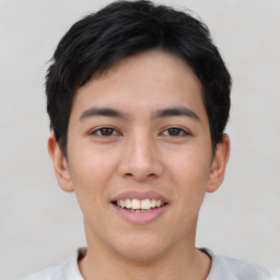 Joyful asian young-adult male with short  black hair and brown eyes