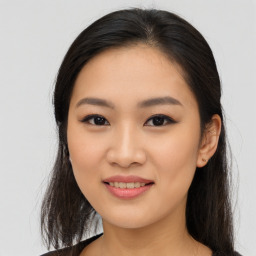 Joyful asian young-adult female with long  brown hair and brown eyes