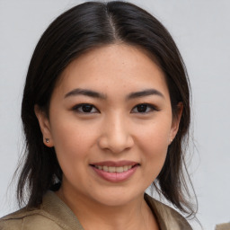 Joyful asian young-adult female with long  brown hair and brown eyes