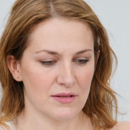 Joyful white young-adult female with long  brown hair and blue eyes