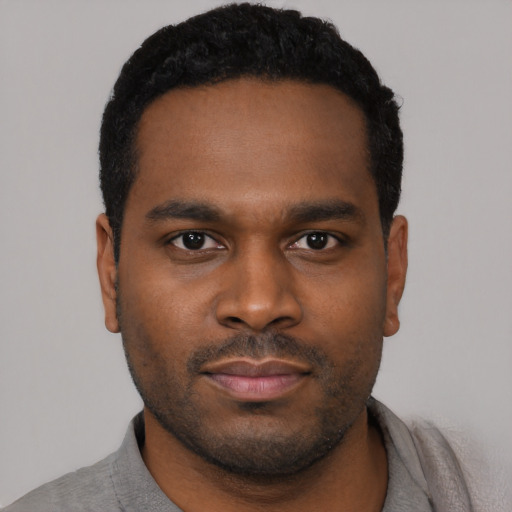Neutral black young-adult male with short  black hair and brown eyes