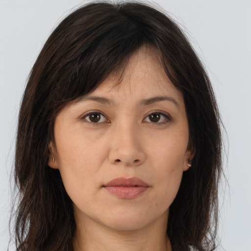 Joyful asian young-adult female with long  brown hair and brown eyes