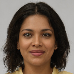 Joyful black young-adult female with medium  brown hair and brown eyes