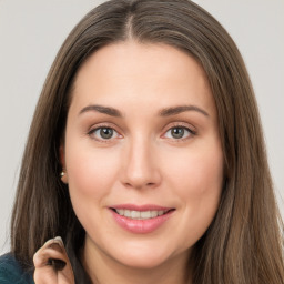 Joyful white young-adult female with long  brown hair and grey eyes