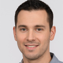 Joyful white young-adult male with short  brown hair and brown eyes