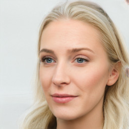 Joyful white young-adult female with long  brown hair and blue eyes