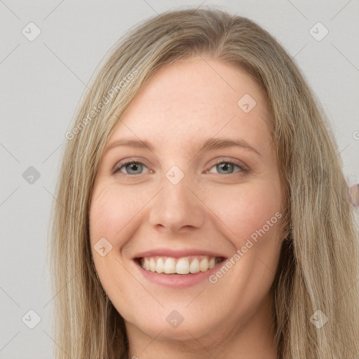 Joyful white young-adult female with long  brown hair and blue eyes