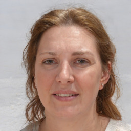 Joyful white adult female with medium  brown hair and blue eyes