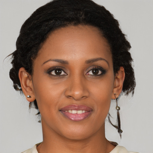 Joyful black young-adult female with medium  brown hair and brown eyes