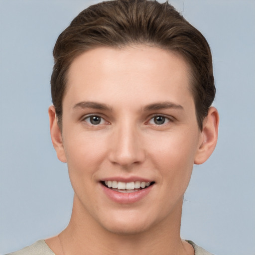 Joyful white young-adult female with short  brown hair and grey eyes