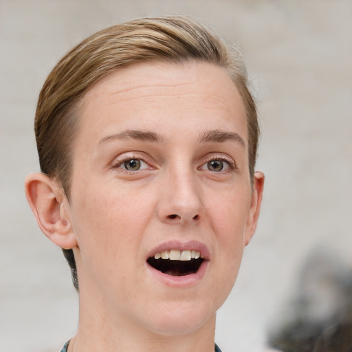 Joyful white young-adult female with short  brown hair and blue eyes