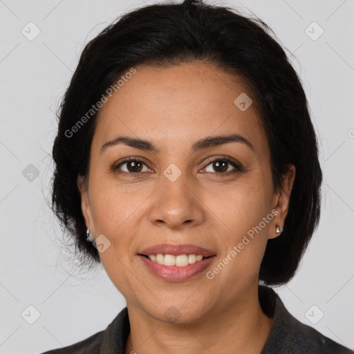 Joyful latino adult female with medium  brown hair and brown eyes