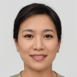 Joyful asian young-adult female with short  brown hair and brown eyes