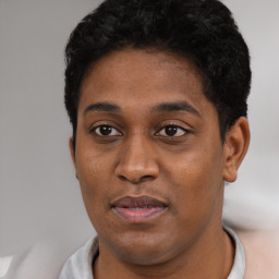 Joyful black young-adult female with short  black hair and brown eyes