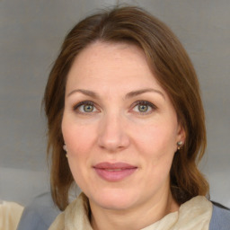 Joyful white adult female with medium  brown hair and blue eyes