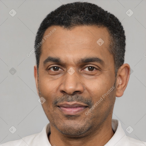 Joyful latino adult male with short  black hair and brown eyes