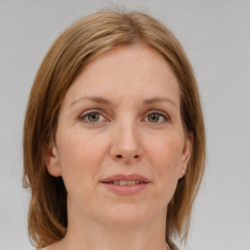 Joyful white adult female with medium  brown hair and green eyes