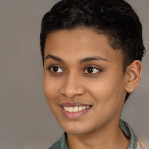 Joyful latino young-adult female with short  black hair and brown eyes