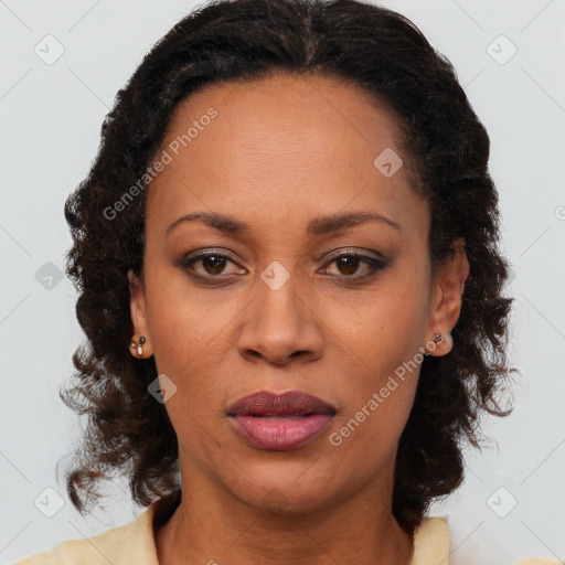 Joyful black adult female with medium  brown hair and brown eyes