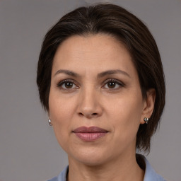 Joyful white adult female with medium  brown hair and brown eyes