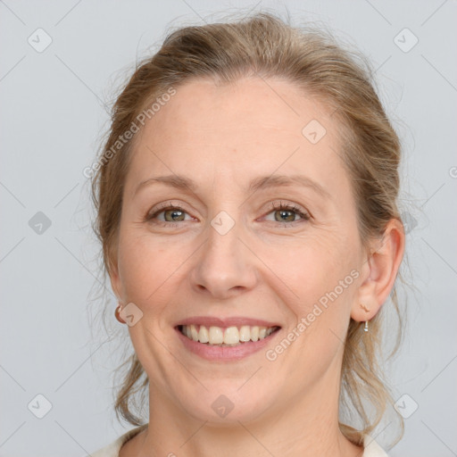 Joyful white adult female with medium  brown hair and blue eyes