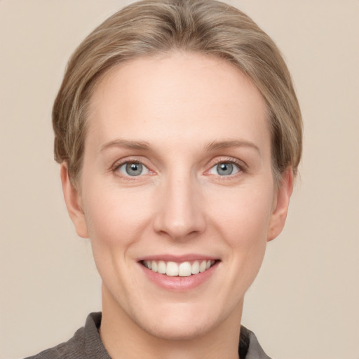 Joyful white young-adult female with short  brown hair and grey eyes