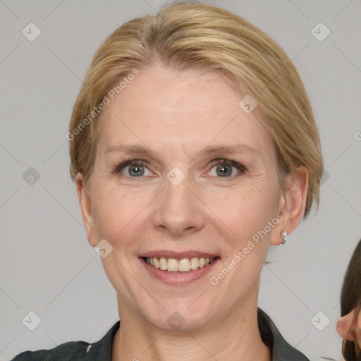 Joyful white adult female with medium  brown hair and blue eyes