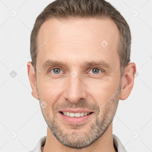 Joyful white adult male with short  brown hair and brown eyes