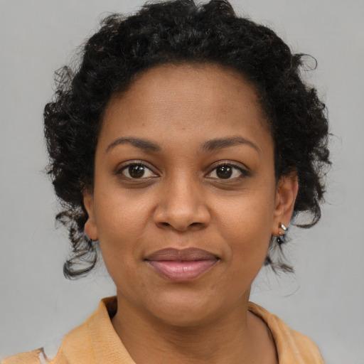 Joyful black young-adult female with medium  brown hair and brown eyes