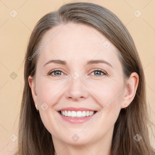 Joyful white young-adult female with long  brown hair and grey eyes