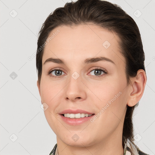 Joyful white young-adult female with short  brown hair and grey eyes