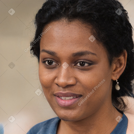 Joyful black young-adult female with long  black hair and brown eyes